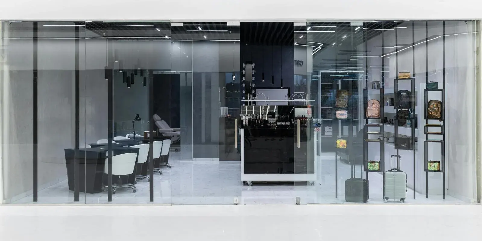 A glass-fronted retail showroom with display shelving seen through the storefront